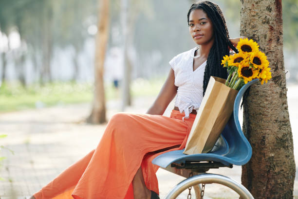 istock Pretty woman resting in park 1203764943