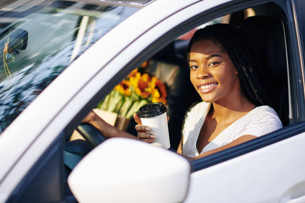 istock Pretty woman driving car 1203764987