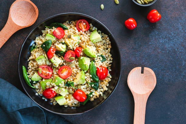 istock Healthy salad with bulgur, avocado, spinach and cherry tomatoes. 1203766261