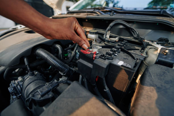istock Woman checking car battery 1203766379