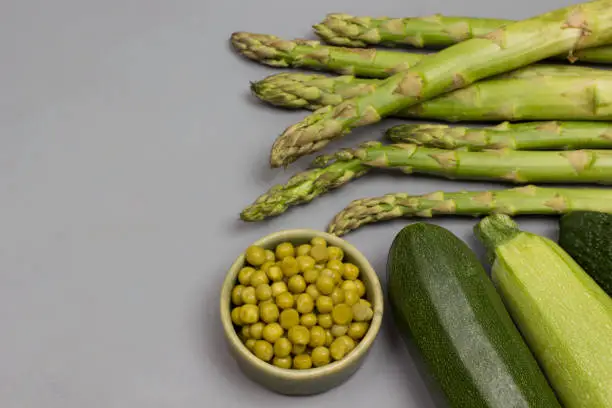 Photo of Set of green vegetables on gray background