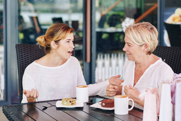 istock Mother and daughter discussing news 1203766813