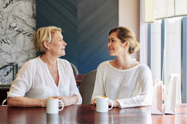 istock Mother and daughter in cafe 1203766849