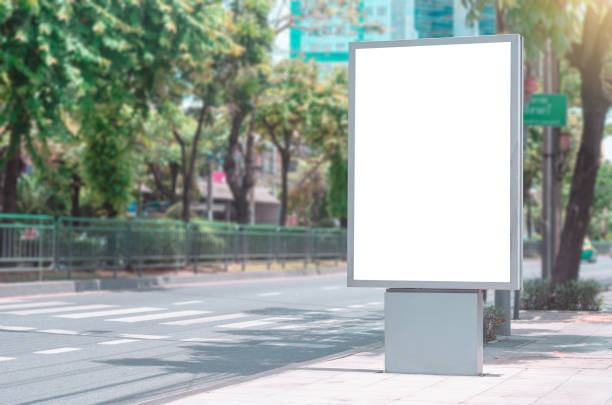 istock led blank billboard white screen side road in city. ad mockup copy space for advertising banner near bus stop in metropolis. 1203767614