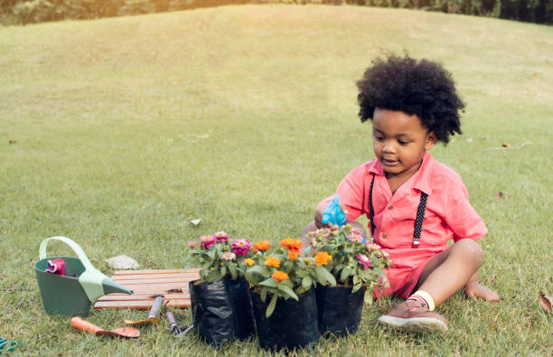 istock African boy is playing in the garden 1203768176