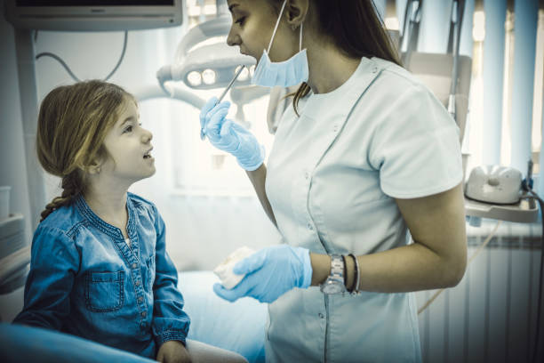istock Cute girl teeth checkup at dentist's office 1203769328