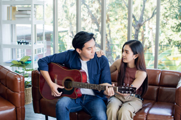 istock A man is playing guitar for his girlfriend 1203770218
