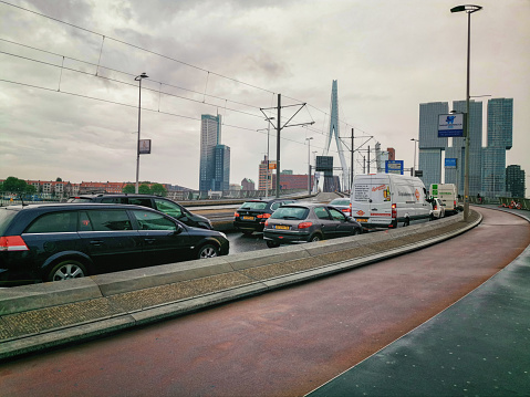 Rotterdam, Netherlands - August 9, 2019: Traffic stops on the Erasmus Bridge in Rotterdam. The raised section is seen further under the pylon of the bridge.