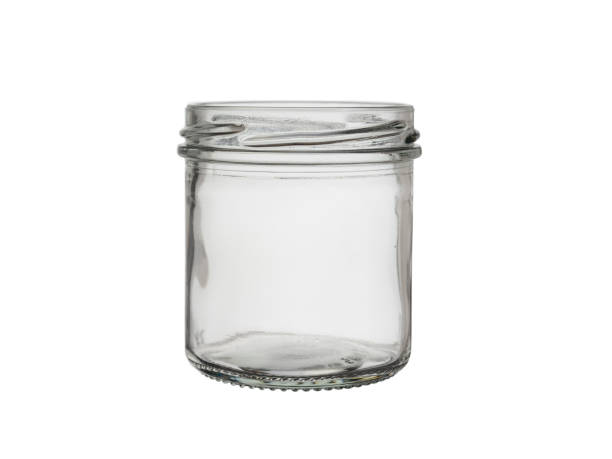 istock An open, empty glass jar isolated on a white background. 1203771684