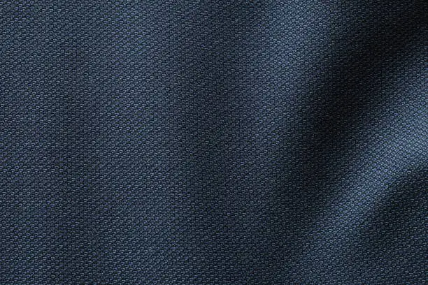 Photo of Close up shot of midnight dark blue formal suit cloth textile surface. wool fabric texture for important luxury evening or night event. Wallpaper and background with copy space for text