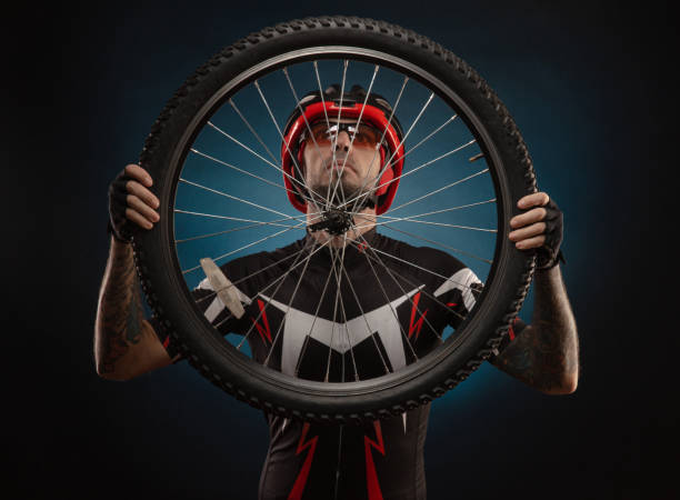 istock guy-cyclist in a Bicycle helmet with a Bicycle wheel 1203771987