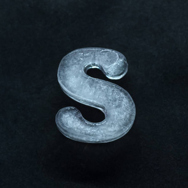 istock Alphabet's letters made out of ice isolated on dark studio background 1203772222