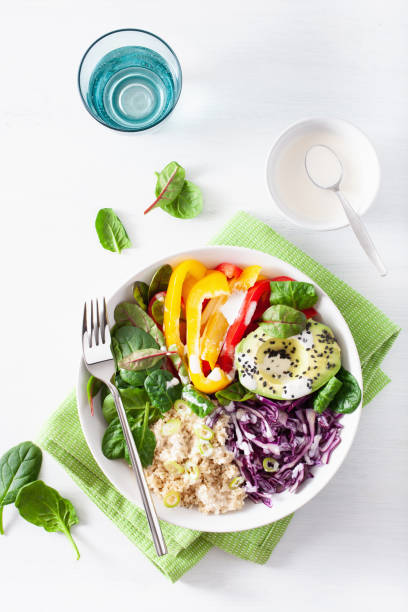 istock veggie couscous lunch bowl with avocado, bell peppers, spinach and red cabbage 1203773780