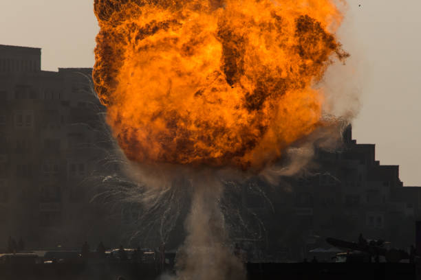Military strike or bomb in war causes fire ball and explosion amid chaos. Military concept. Strength, power, force, fire, explosion. stock photo