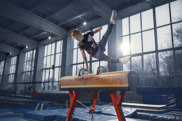 istock Little male gymnast training in gym, flexible and active 1203774253