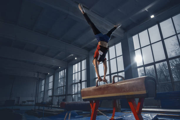 istock Little male gymnast training in gym, flexible and active 1203774281