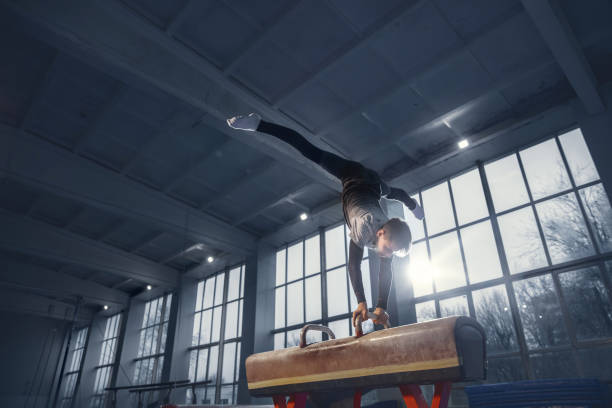 istock Little male gymnast training in gym, flexible and active 1203774314