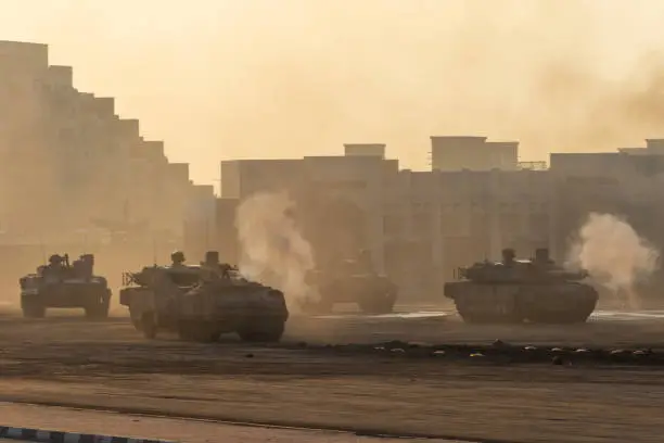 Series of Army tanks shooting and driving in the desert town in war and military conflict. Military concept of war and explosions.