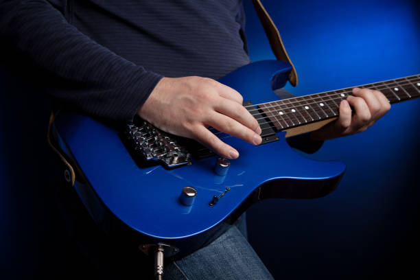 istock musician rock guitarist playing a blue guitar 1203774977