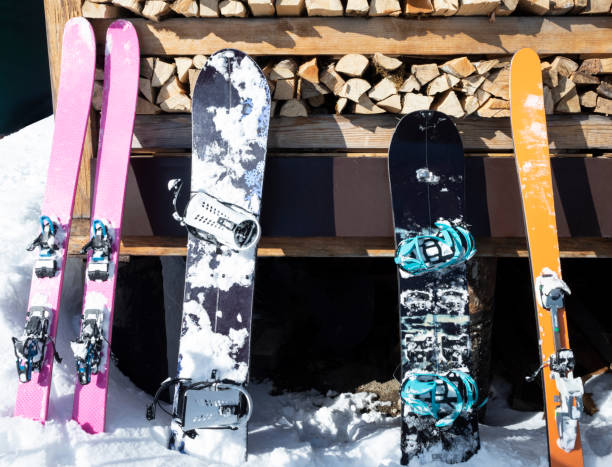 istock Alpine skis and splitboards leaning on wooden wall. 1203775671