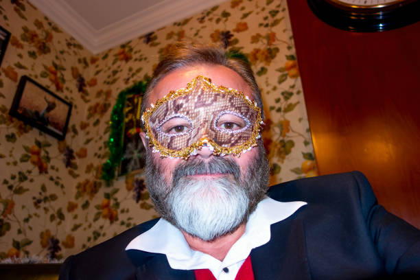 Active Senior Man having fun in night club with mask