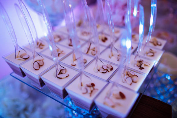 Candy bar on wedding ceremony with a lot of different cupcakes, modern desserts, mousses and jellies. selective focus.