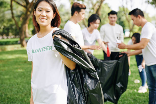 istock Volunteer collecting garbage in park 1203778143