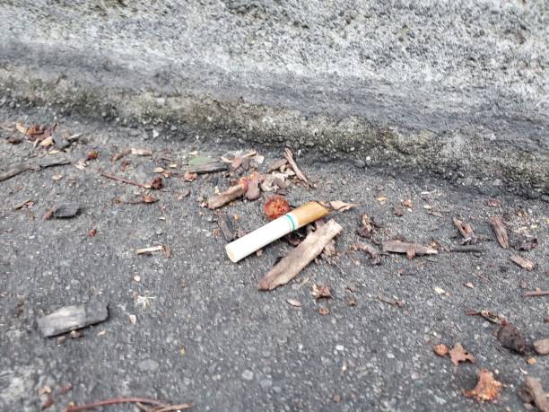 istock Cigarette Stick On Gray Concrete Floor 1203778928