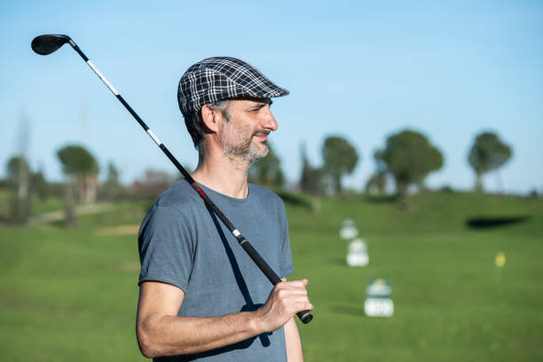 istock golf player with cap and club over his shoulder on a driving course 1203780901