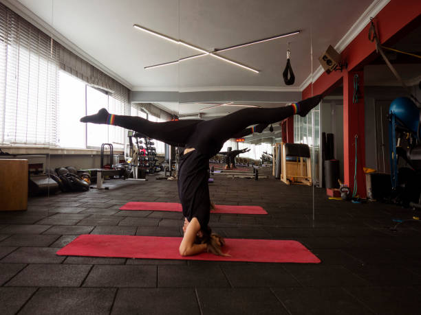 istock Young  woman in yoga pose in studio 1203783149