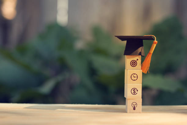 istock Arranging wood cube block stacking with icon business strategy and graduation cap, diploma in classroom. graduate certificate program, Education insight concept 1203783275