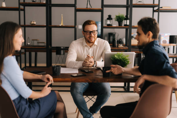 istock Young business team coworkers talking at work, discussing new project ideas 1203783344