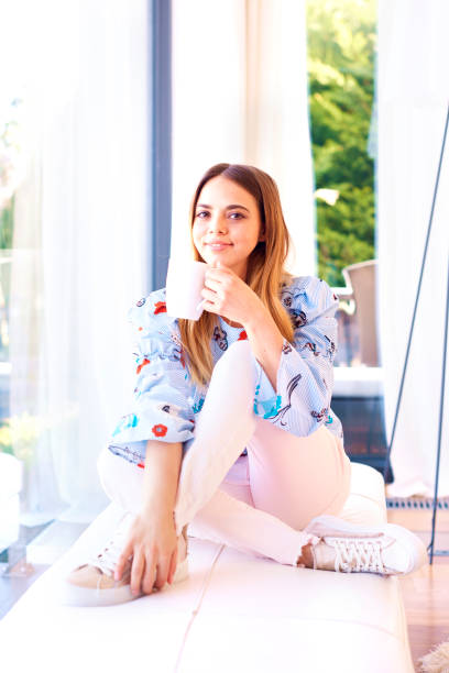 istock Young relaxing at home and enjoying morning tea 1203783467
