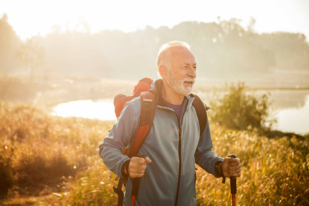 istock Senior hiker on a footpath in morning 1203783500