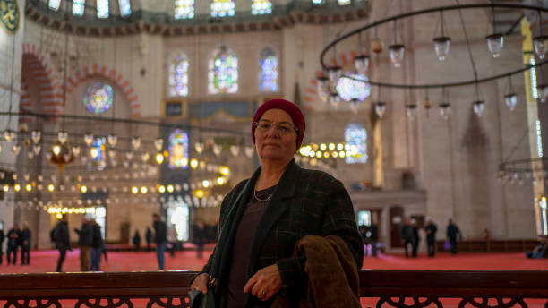 istock Woman praying inside a mosque 1203783560