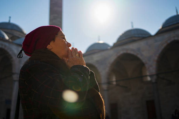 istock Woman praying near a mosque 1203784189