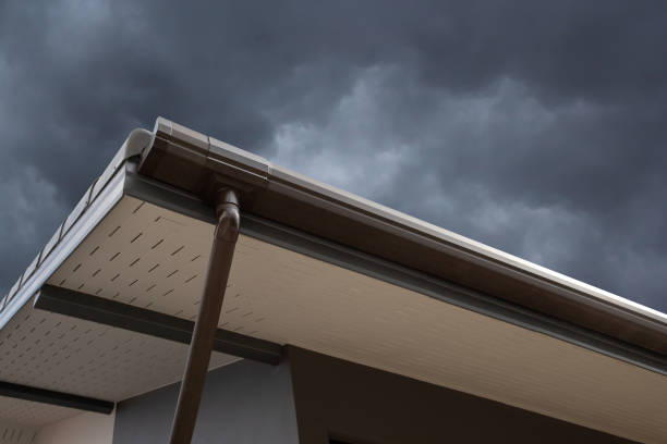 brown rain gutter of house with dark cloud and sky. concept : preparing maintenance rain gutter before rainy season.
