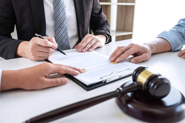 istock Young couple telling their problems in the courthouse to getting divorced or premarital agreement in lawyers office, deciding on marriage divorce concept 1203784591
