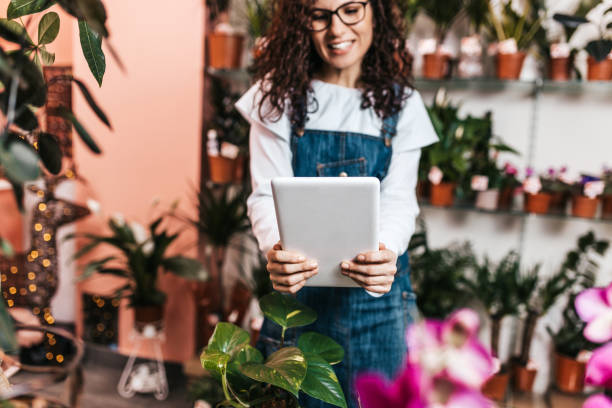 istock Young woman working in a flower shop 1203785992
