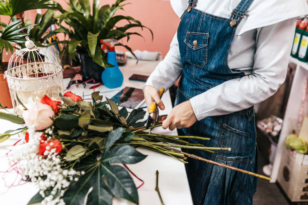 istock Young woman working in a flower shop 1203786106