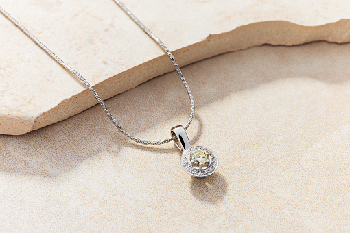 Elegant white gold necklace with diamonds. Small silver charm necklace with gemstones