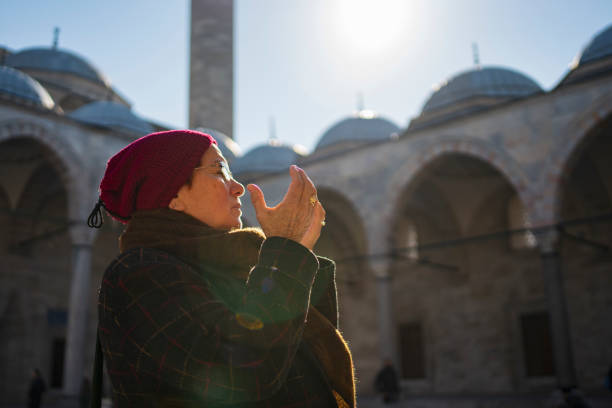 istock Woman praying near a mosque 1203787131