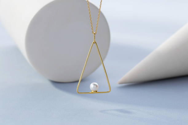 istock Triangle shape gold pendant necklace with pearl 1203787164
