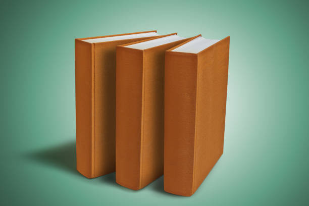 istock Three Closed big book with hardcover on green gradient background. 1203787165