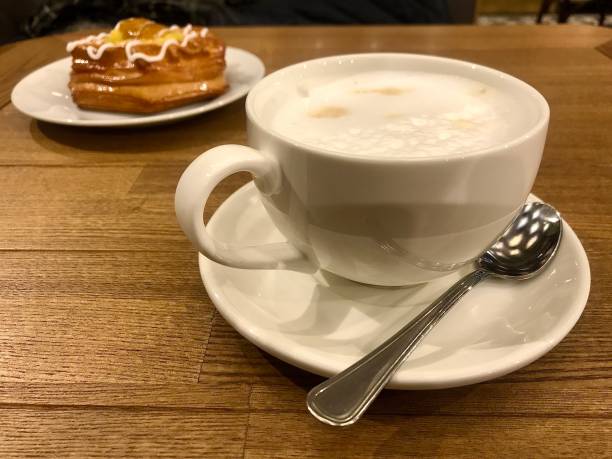 istock cappuccino Cup on a large wooden table 1203791741