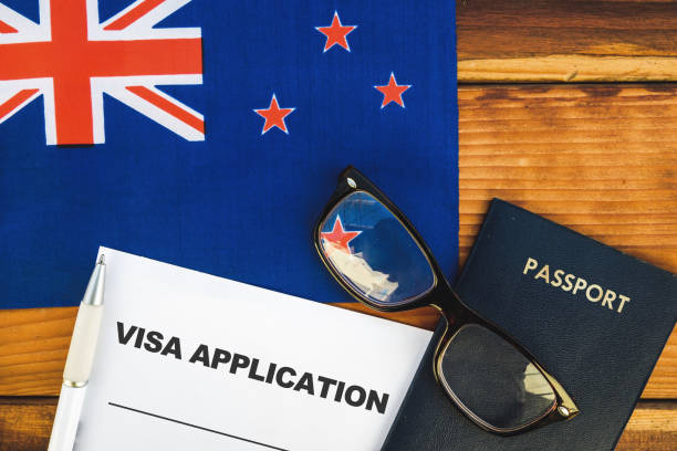 New Zealand visa application Flag of New Zealand , visa application form and passport on table embassy photos stock pictures, royalty-free photos & images