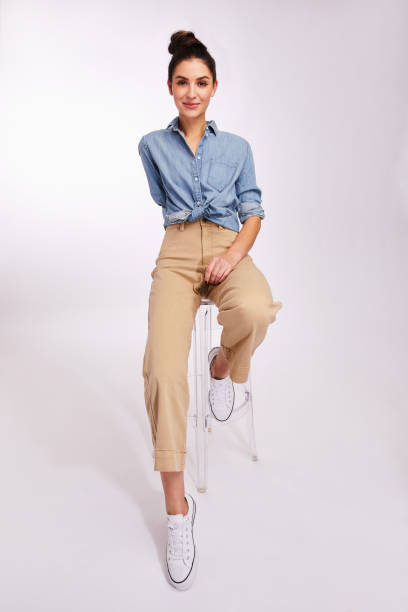 istock Young brunette woman sitting on a stool and smiling 1203794005