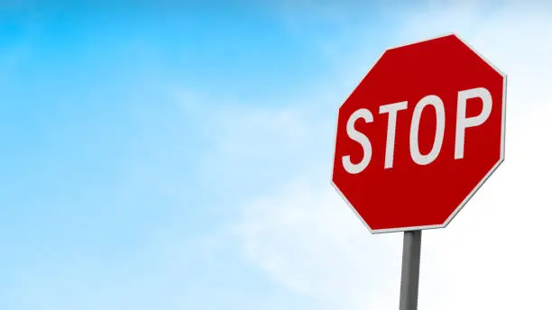 3D Rendering, Close up of stop traffic sign with cloudy blue sky background.