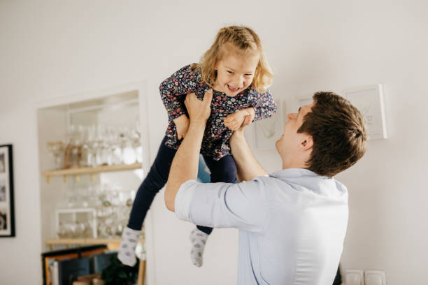 istock Father and daughter playing at home 1203795601