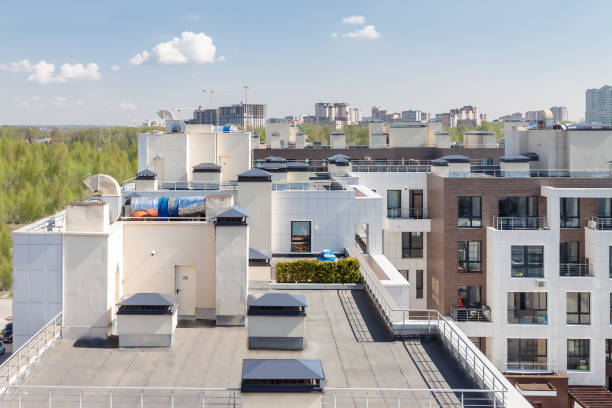 Flat roof with air conditioners on top modern apartment house building exterior mixed-use urban multi-family residential district area development. stock photo